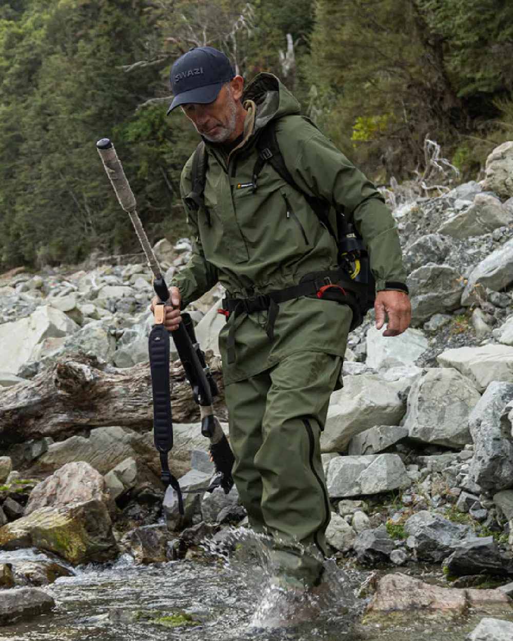 Olive coloured Mens Swazi Mens Tahr Ultralite Jacket on rock background #colour_olive