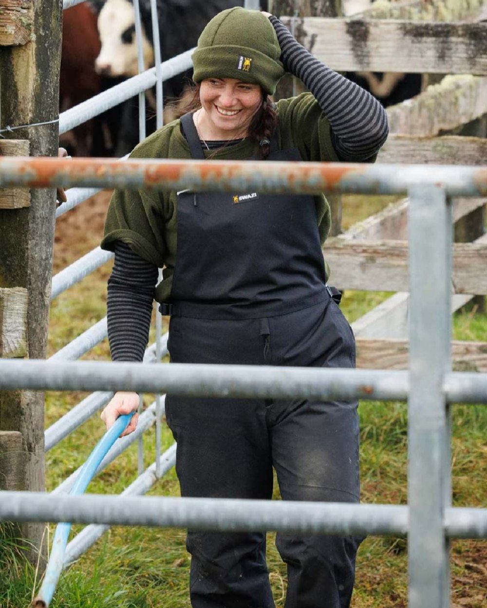 Black coloured Swazi Mens Torrent Bib Overpants on fences background #colour_black