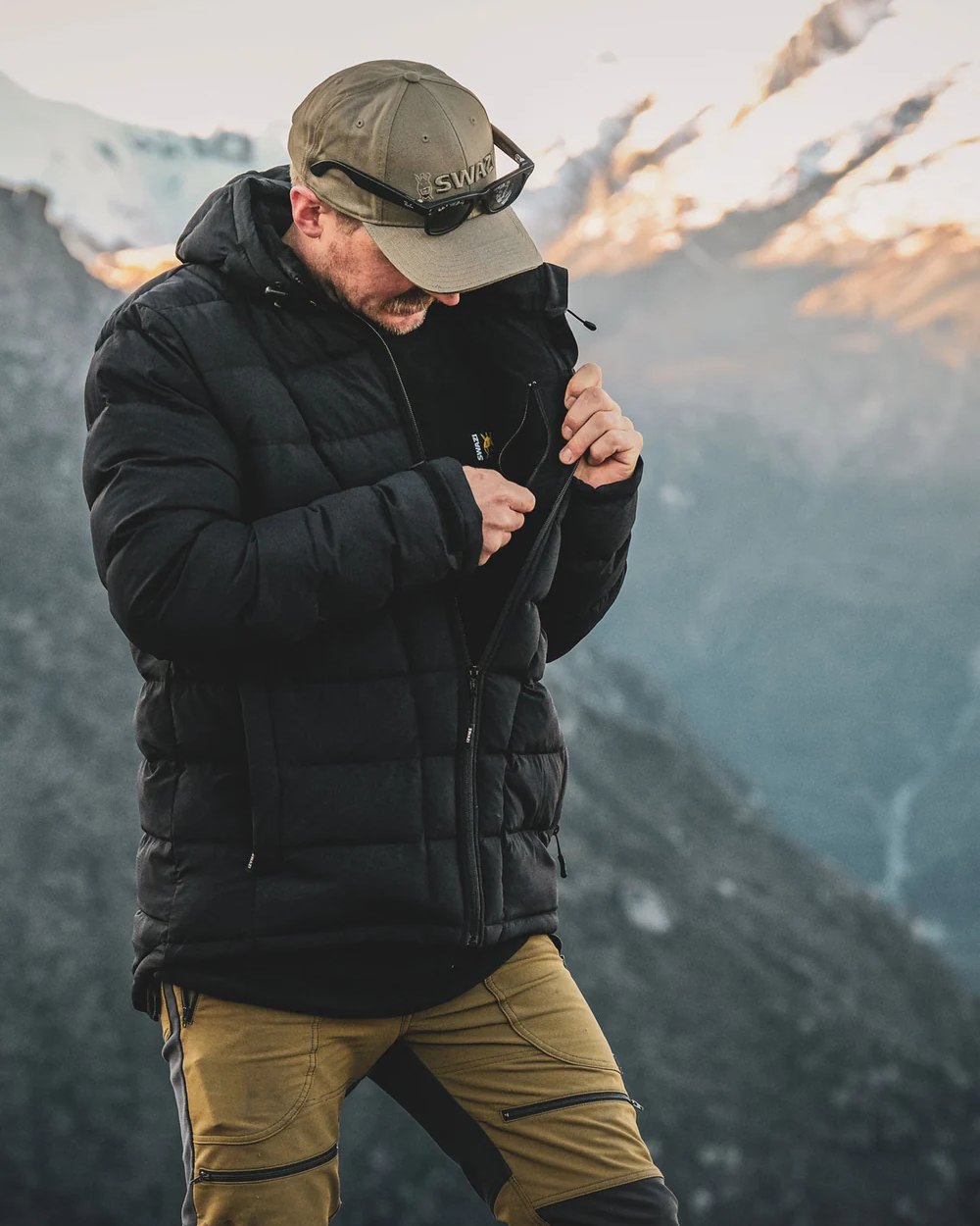 Black coloured Swazi Puffadder Jacket on blurry background #colour_black