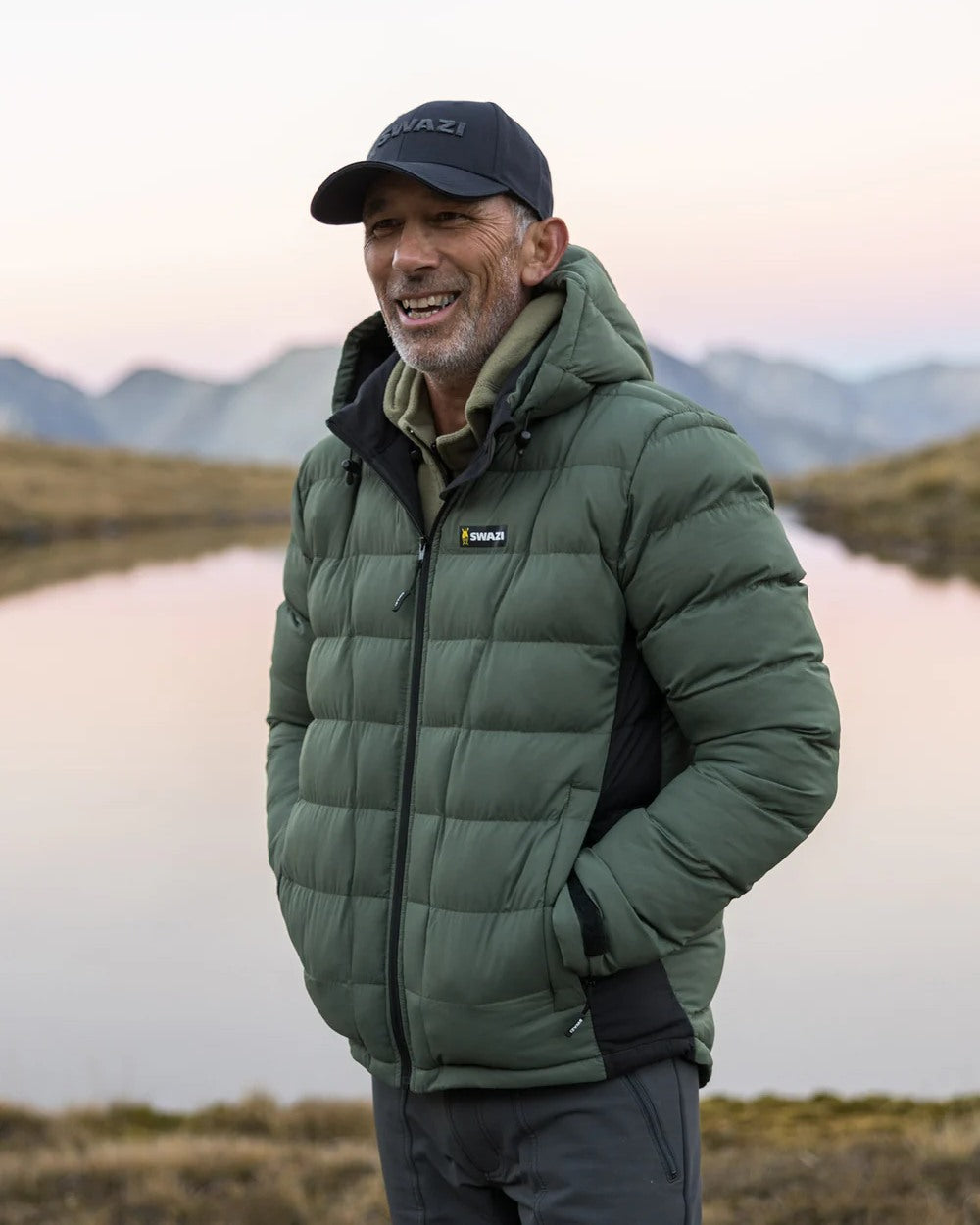 Olive coloured Swazi Puffadder Jacket on blurry background #colour_olive