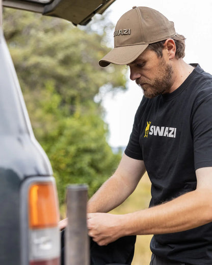 Black Coloured Swazi Tee on blurry background #colour_black