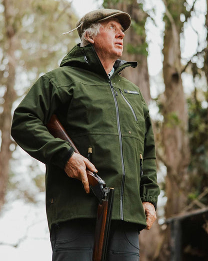 Olive coloured Swazi The Ibex Jacket on blurry background #colour_olive