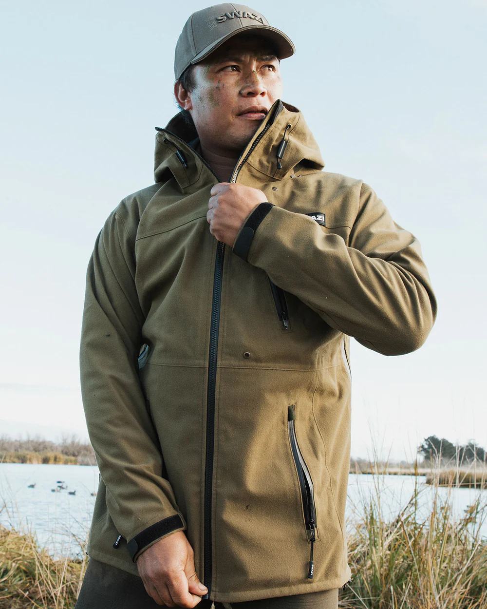 Tussock Green coloured Swazi The Ibex Jacket on sky background #colour_tussock-green