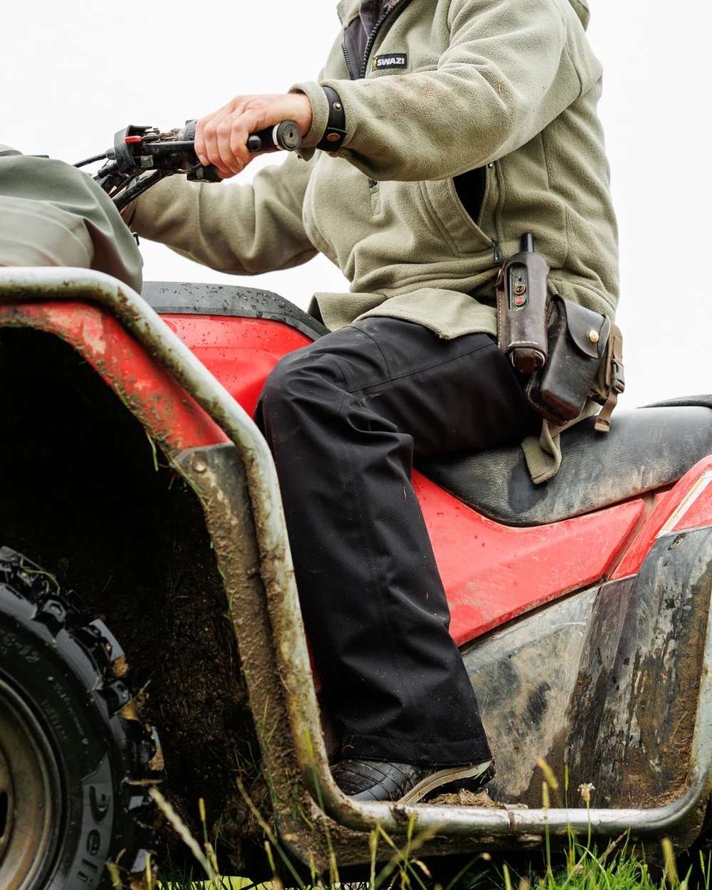 Black Coloured Swazi Torrent Overpants on tractor background #colour_black