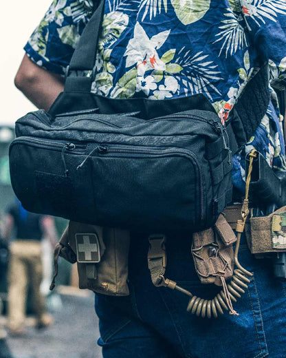 Black Coloured Viper VX Buckle Up Sling Pack on blurry background #colour_black