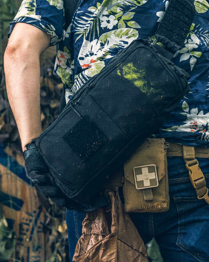 Black Coloured Viper VX Buckle Up Sling Pack on blurry background #colour_black