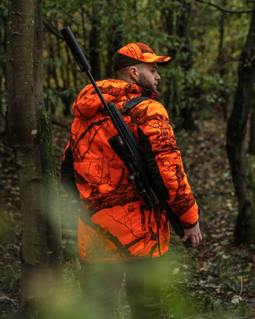 Realtree Edge Orange Coloured Deerhunter Eagle Cap On A Forest Background #colour_realtree-edge-orange