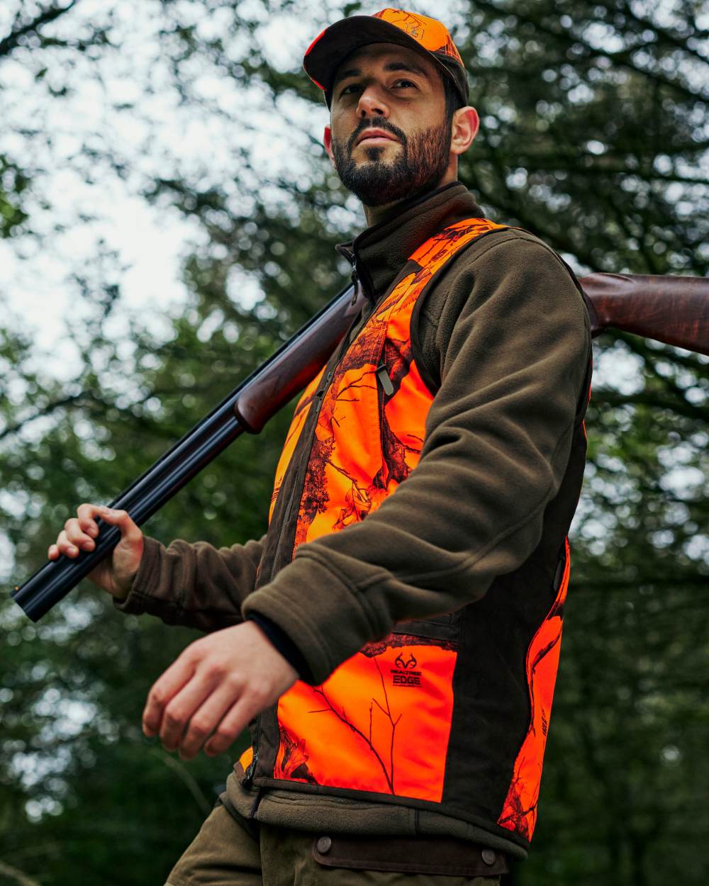 Realtree Edge Orange Coloured Deerhunter Eagle Cap On A Forest Background #colour_realtree-edge-orange