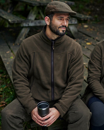 Tarmac Green Coloured Deerhunter Eagle Fleece Jacket On A Forest Background #colour_tarmac-green