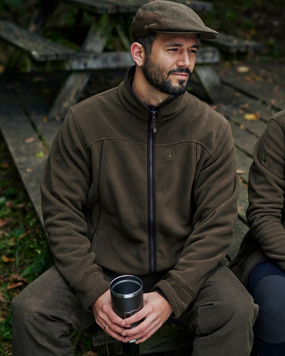 Tarmac Green coloured Deerhunter Eagle Trouser on a forest background #colour_tarmac-green