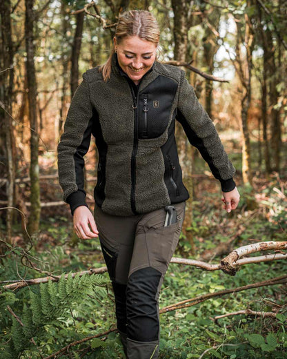 Black Bark Green coloured Northward Trousers on Forest background #colour_black-bark-green