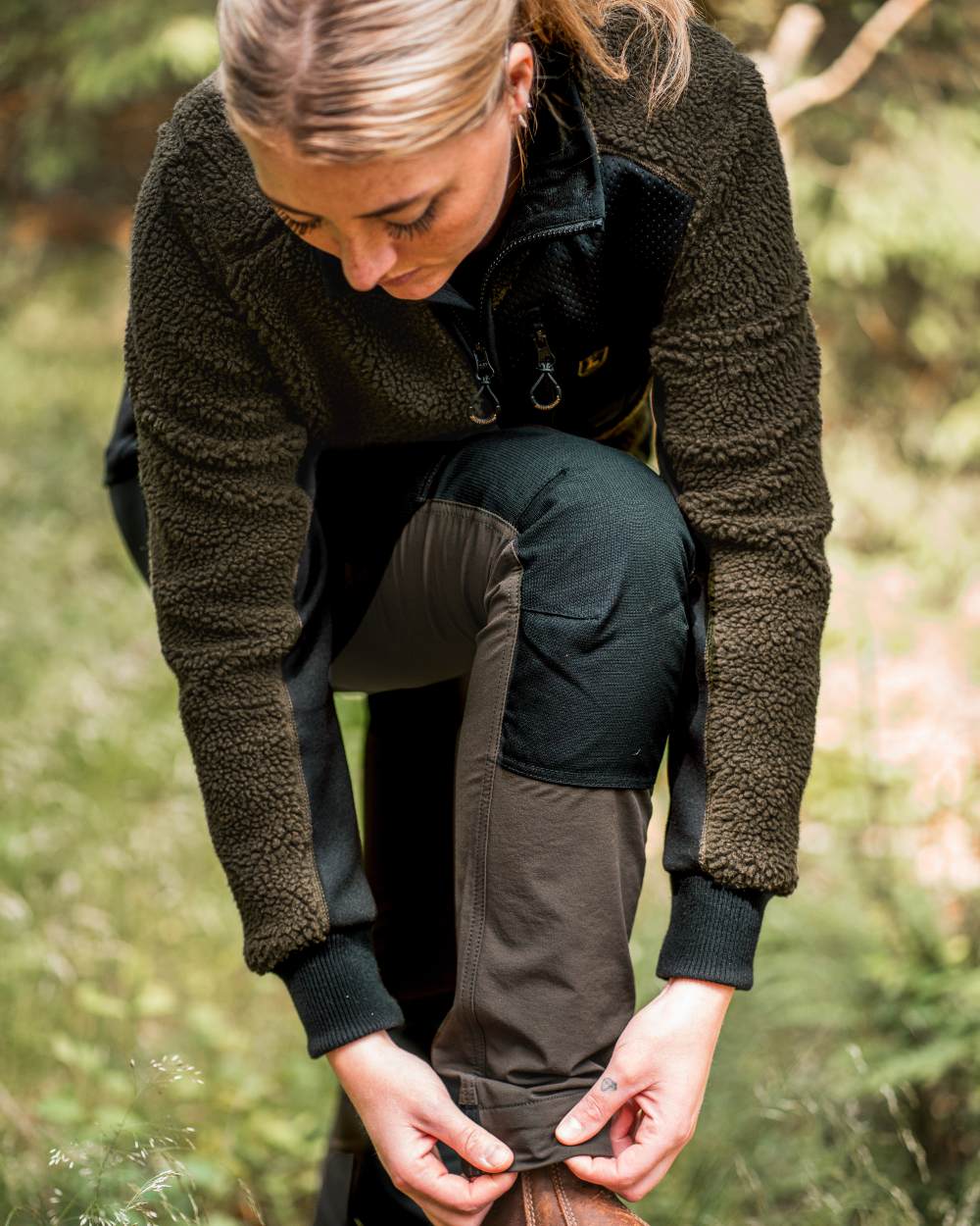 Black Bark Green coloured Northward Trousers on Forest background #colour_black-bark-green
