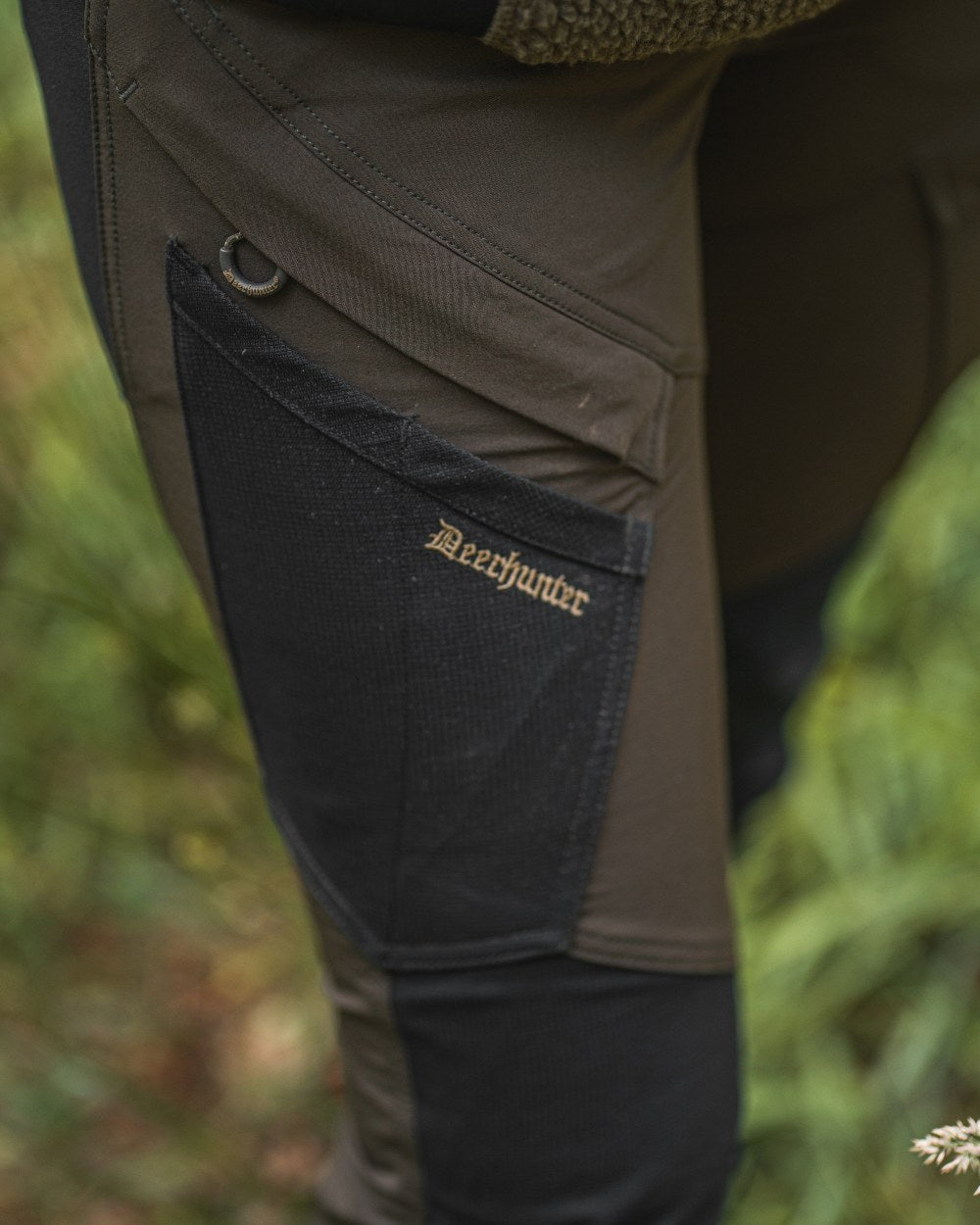 Black Bark Green coloured Northward Trousers on Forest background #colour_black-bark-green