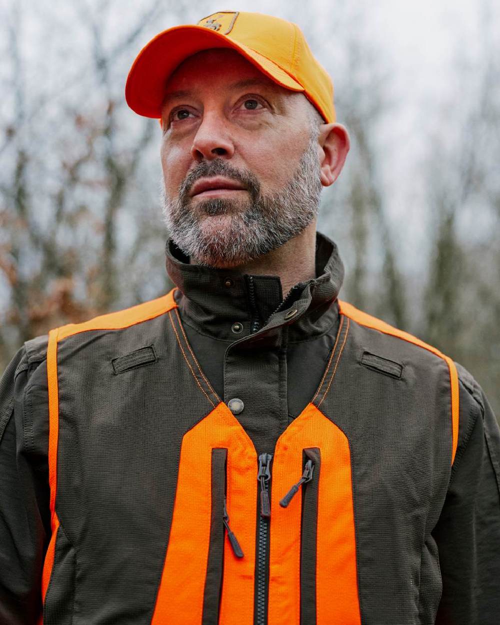 Orange coloured Deerhunter Shield Cap on blurry background #colour_orange