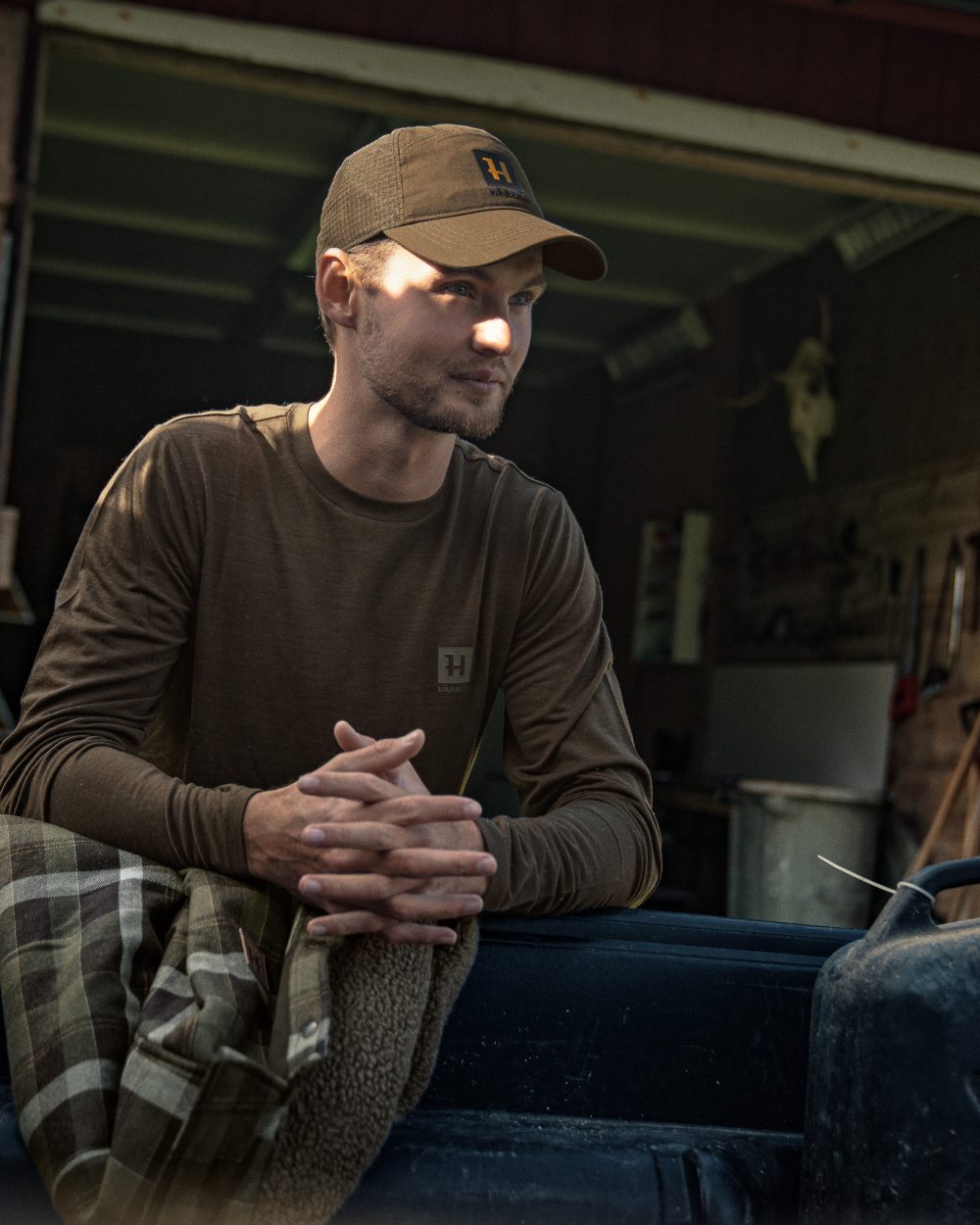 Shadow Brown Coloured Harkila Base All Season Long Sleeve T-Shirt On A Backyard Background #colour_shadow-brown