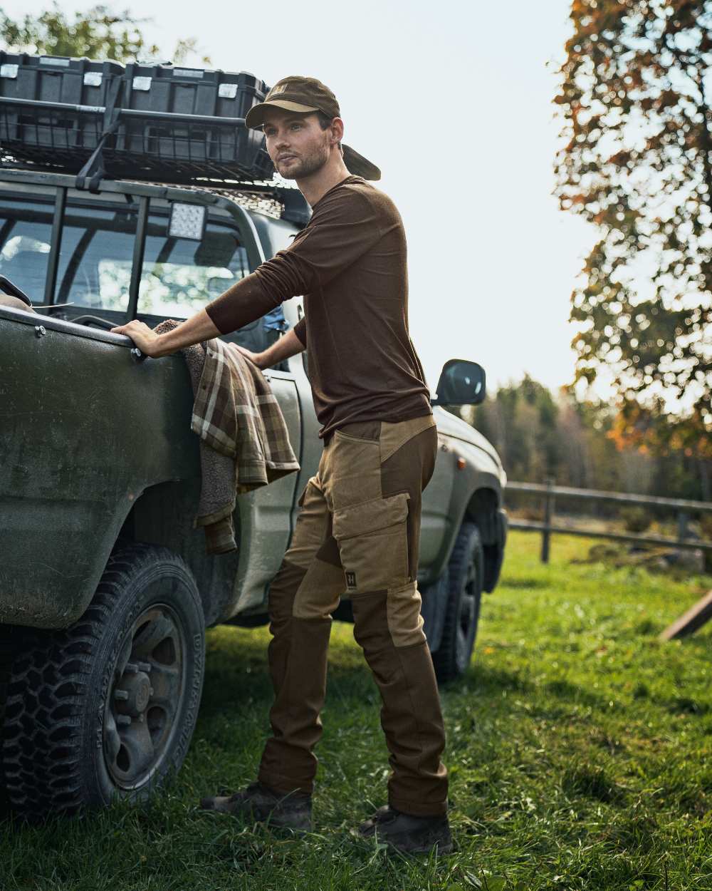 Willow Green Coloured Harkila Base All Season Long Sleeve T-Shirt On A Backyard Background #colour_willow-green