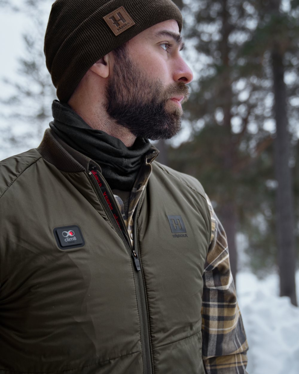 Willow Green Coloured Harkila Clim8 Base Waistcoat on snow background #colour_willow-green