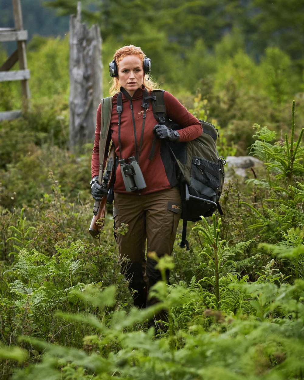 Hunting Green Coloured Harkila Metso Rucksack Chair Backpack on forest background #colour_hunting-green