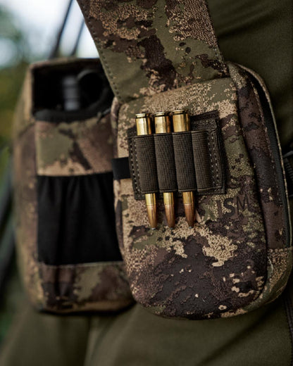 AXIS MSPForest Coloured Harkila Utility Camo Pouch on blurry background #colour_axis-mspforest