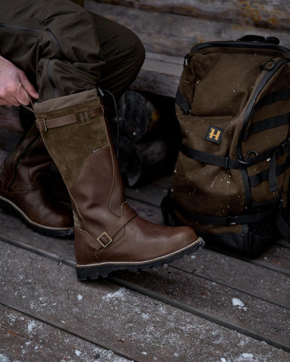 Willow Green Shadow Brown Coloured Harkila Visent 2.0 GTX Boots on snow background #colour_willow-green-shadow-brown
