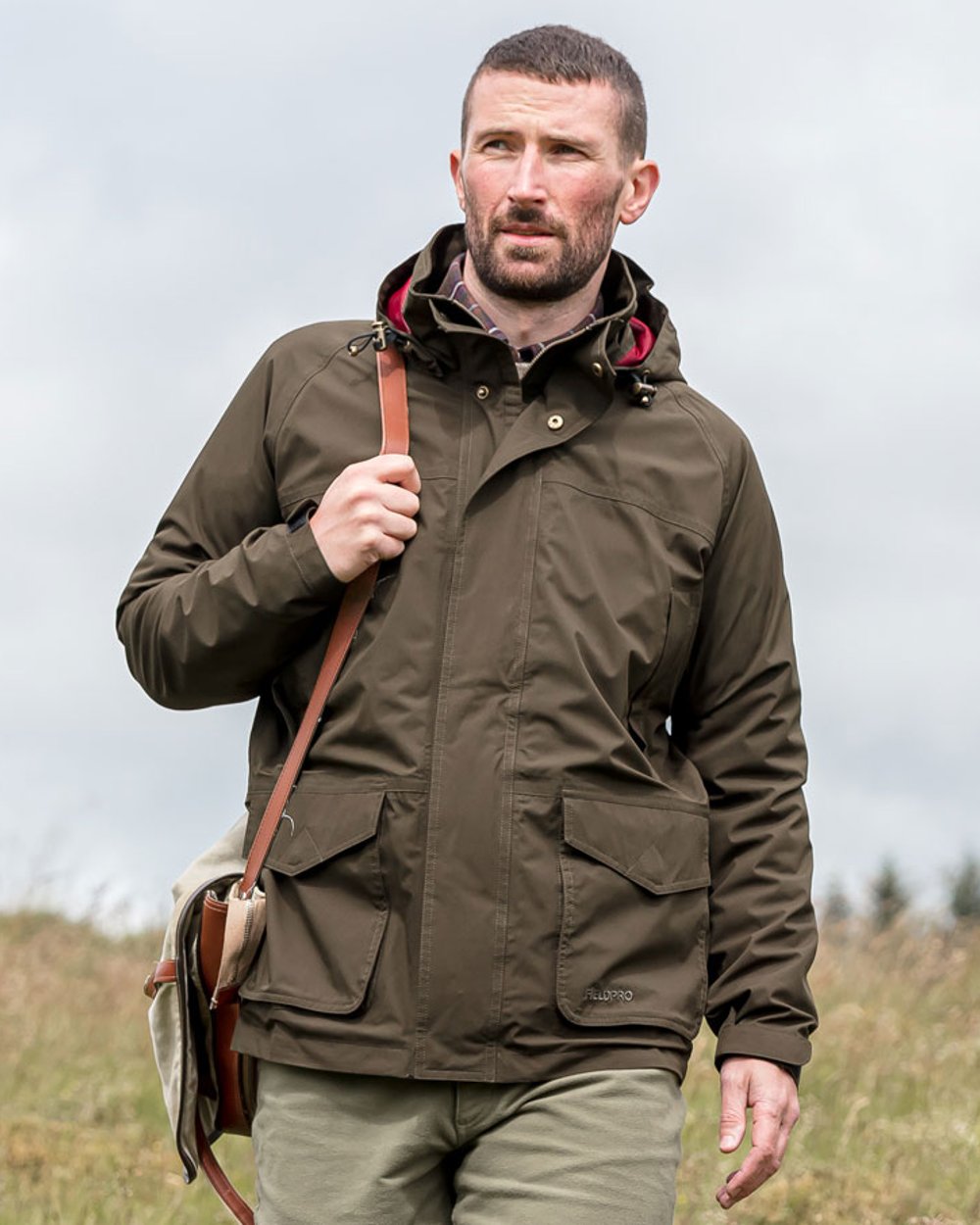 Fen Green Coloured Hoggs of Fife Culloden Waterproof Field Jacket on forest background #colour_fen-green