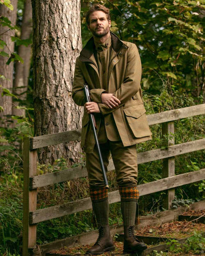 Bracken Coloured House of Cheviot Chessboard Socks On A Forest Background #colour_bracken