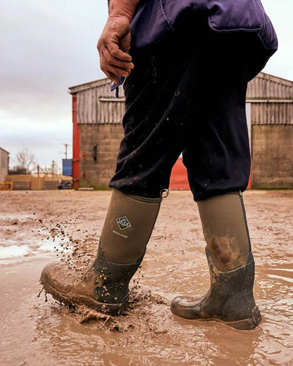 Moss Coloured Muck Boots Arctic Sport Tall Wellingtons On A Shelter Background #colour_moss