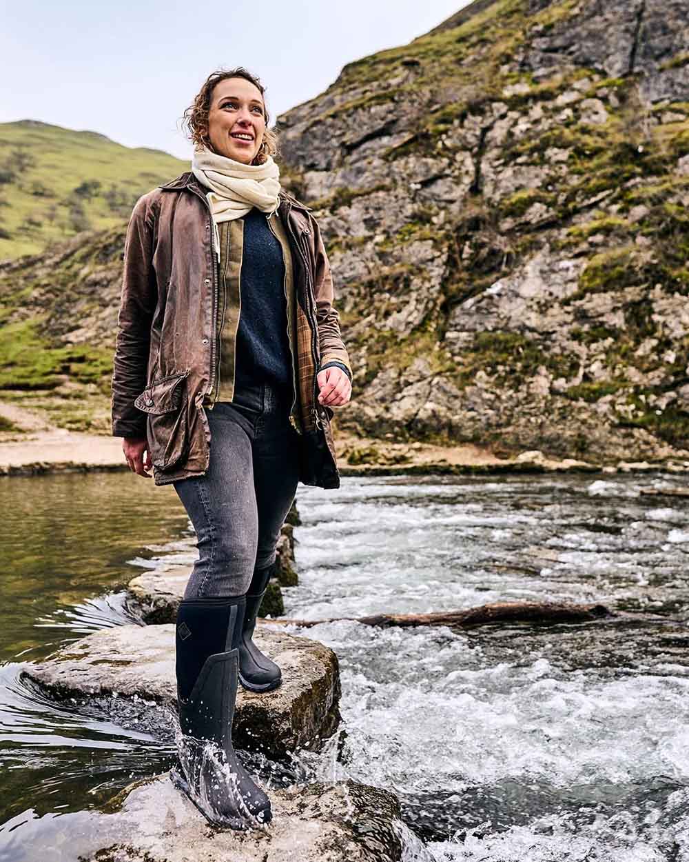 Black coloured Muck Boots Womens Artic Sport II Tall Wellingtons on River background #colour_black