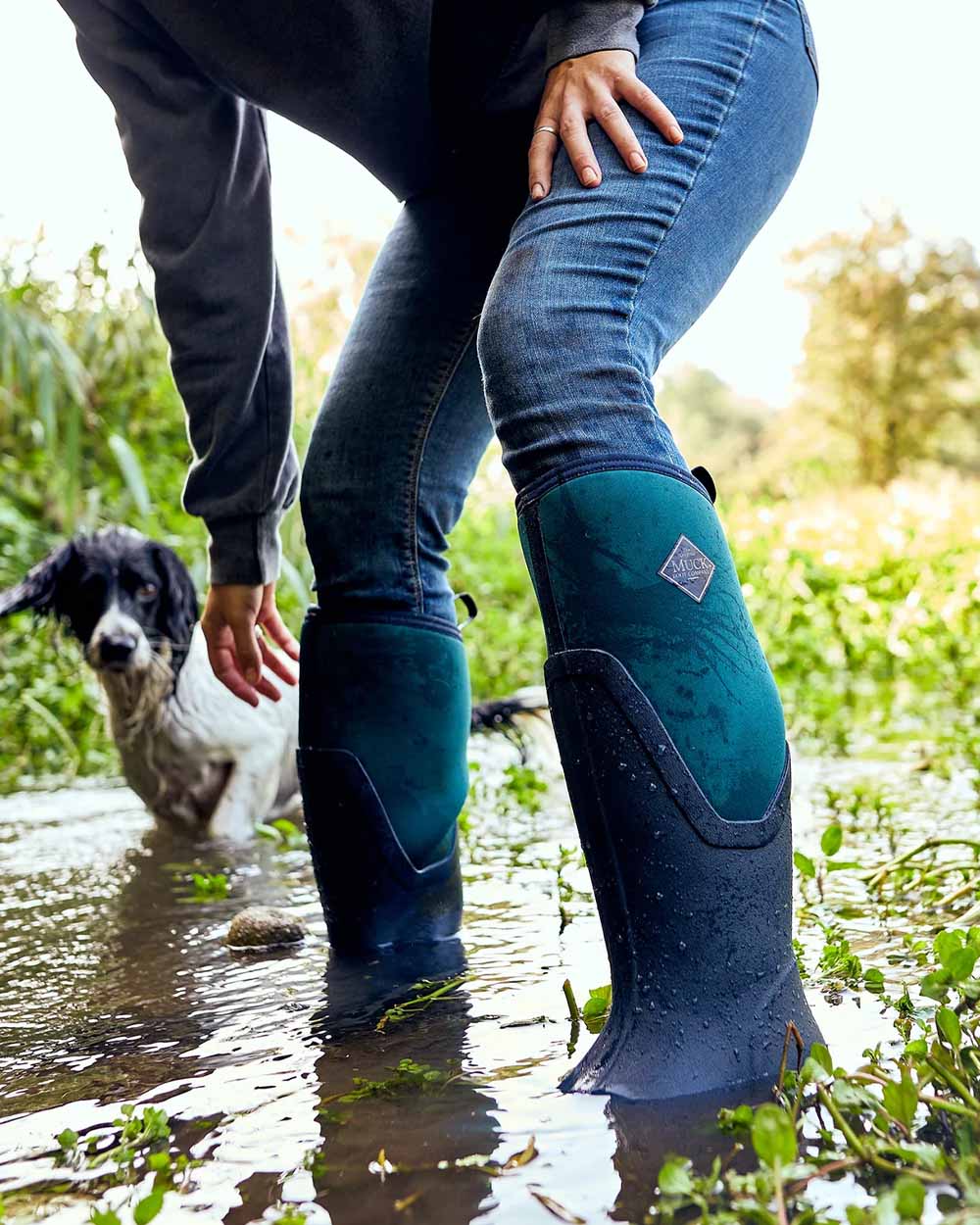 Navy/Spruce coloured Muck Boots Womens Artic Sport II Tall Wellingtons on Stream background #colour_navy-spruce