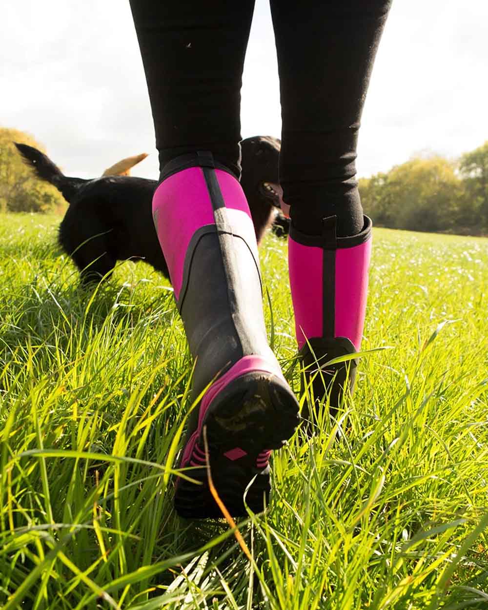 Hot Pink coloured Muck Boots Womens Artic Sport II Tall Wellingtons on Grassy background #colour_pink