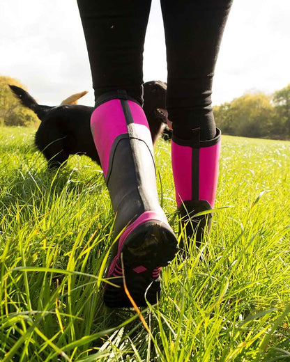 Hot Pink coloured Muck Boots Womens Artic Sport II Tall Wellingtons on Grassy background #colour_pink