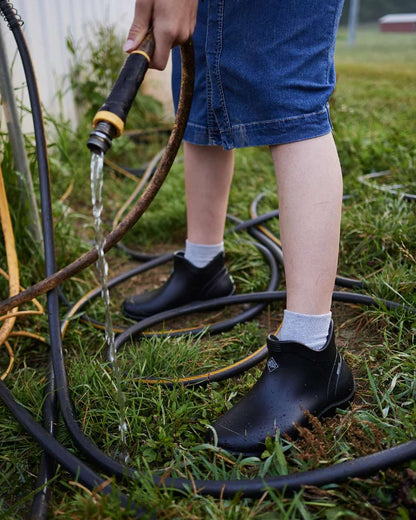 Black Coloured Muck Boots Womens Muckster Lite Ankle Boots On A Garden Background #colour_black