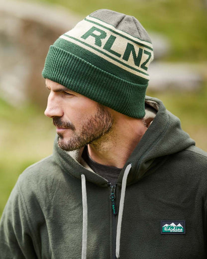 Olive Multi Coloured Ridgeline RLNZ Knitted Beanie On A Blurry Background #colour_olive-multi