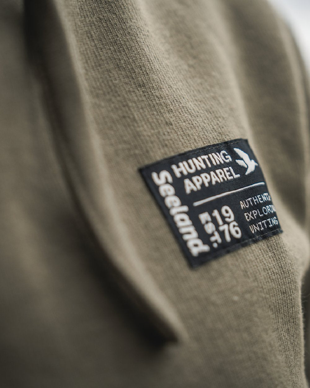 Grape Leaf Coloured Seeland Delta Hoodie on Blurry Background
#colour_grape-leaf