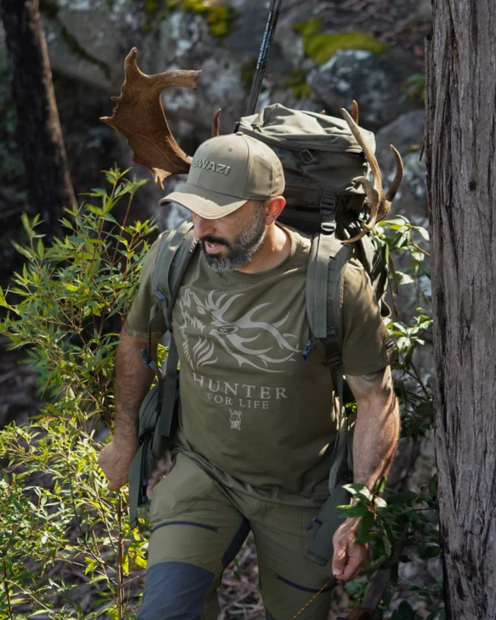 Olive Coloured Swazi Mens Hunter For Life T-Shirt On A Forest Background #colour_olive